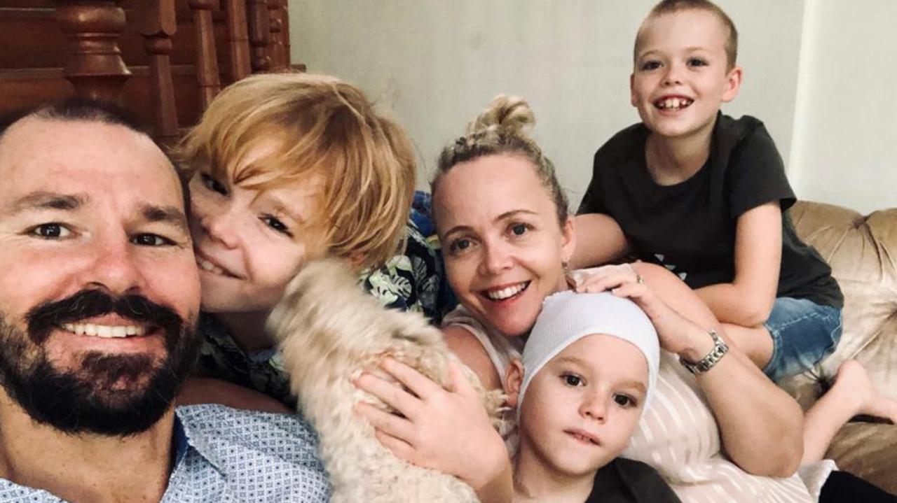 Hayden Price, 8, pictured with his family, has undergone surgery to have a rare melanoma not sun related removed from his head.