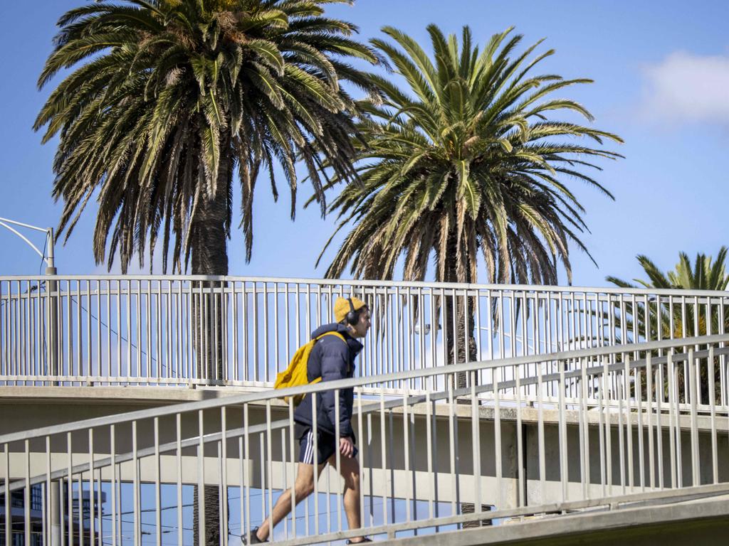 MELBOURNE, AUSTRALIA - NewsWire Photos APRIL 21st, 2021: Melbournians around St Kilda today. Victoria and Tasmania have been hit with a fresh wintry blast overnight, as temperatures plummeted to new lows and brought nearly falls of snow. 
Picture: NCA NewsWire / Wayne Taylor