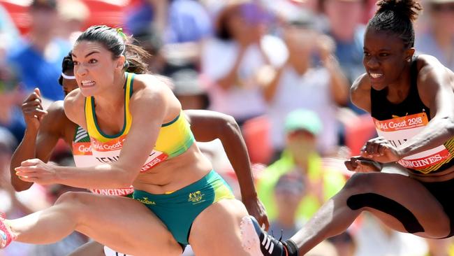 Michelle in action during the 100m hurdles heat.