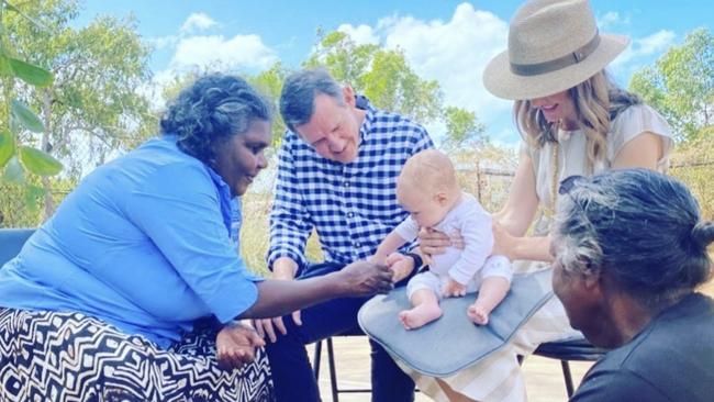 During his trip to Nhulunbuy, a photo was posted on Chief Minister Michael Gunner's social media of his son Hudson, wife Kristy O’Brien and himself during a healing ceremony held by Indigenous elders.