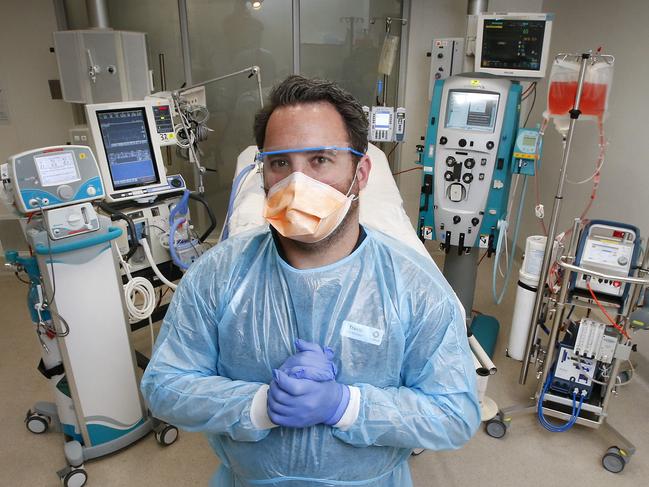 Alfred Hospital Intensive care bed and all the equipment used for coronavirus patient. (L-R) Inhaled Nitric Oxide to Improve oxygen levels the blood, Ventilator, Infusion pump, Heart rate/Blood pressure/ Oxygen Saturation Monitor, Dialysis Machine and ECMO machine (extracorporeal membrane oxygenation). Senior ICU nurse educator Travis Bird stands ready with all the equipment to save lives.   Picture: David Caird