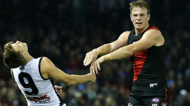 Robbie Gray falls back after being pushed by Brendon Goddard on Saturday night. Picture: George Salpigtidis