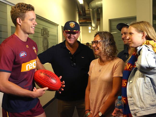 BRISBANE, AUSTRALIA - MAY 18: Lions Debutant Mitchell Hinge celebrates with family as he is presented with his jersey before the start of the round nine AFL match between the Brisbane Lions and the Adelaide Crows at The Gabba on May 18, 2019 in Brisbane, Australia. (Photo by Jono Searle/AFL Photos/Getty Images)