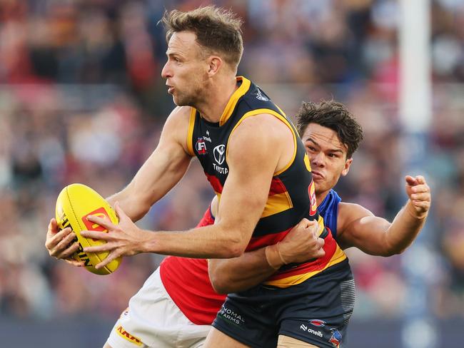 ADELAIDE, AUSTRALIA - MAY 02: Brodie Smith of the Crows is tackled by Cam Rayner of the Lions during the 2024 AFL Round 08 match between the Adelaide Crows and the Port Adelaide Power at Adelaide Oval on May 02, 2024 in Adelaide, Australia. (Photo by James Elsby/AFL Photos via Getty Images)