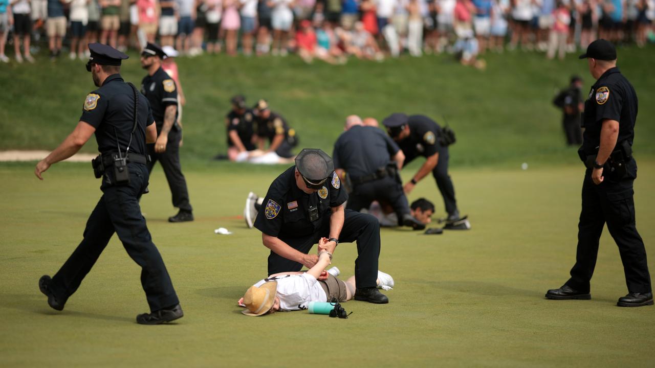 Play was delayed while police ushered them away. (Photo by James Gilbert/Getty Images)