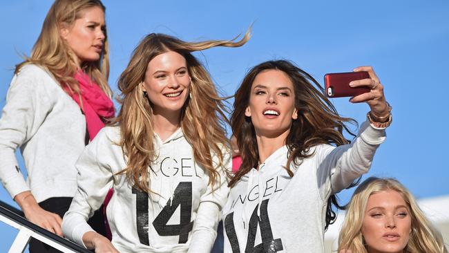 NEW YORK, NY - NOVEMBER 30: (L-R) Victoria's Secret Models Doutzen Kroes, Behati Prinsloo, Alessandra Ambrosio, and Elsa Hosk, depart for London for the 2014 Victoria's Secret Fashion Show at JFK Airport on November 30, 2014 in New York City. (Photo by Mike Coppola/Getty Images for Victoria's Secret)