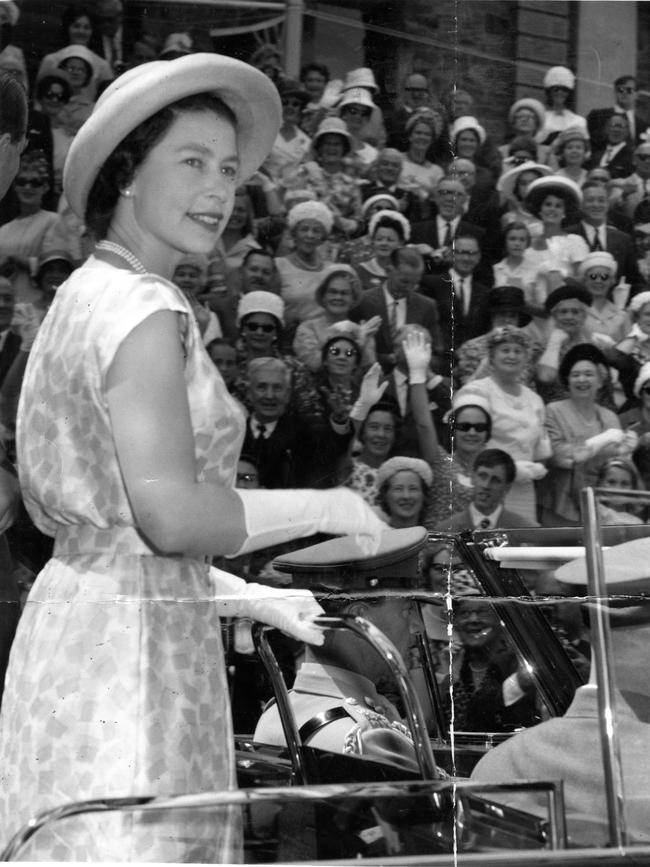 The Queen giving a smile and a wave from the open Royal car to the crowd that lined the route of the Royal progress from Port Adelaide.