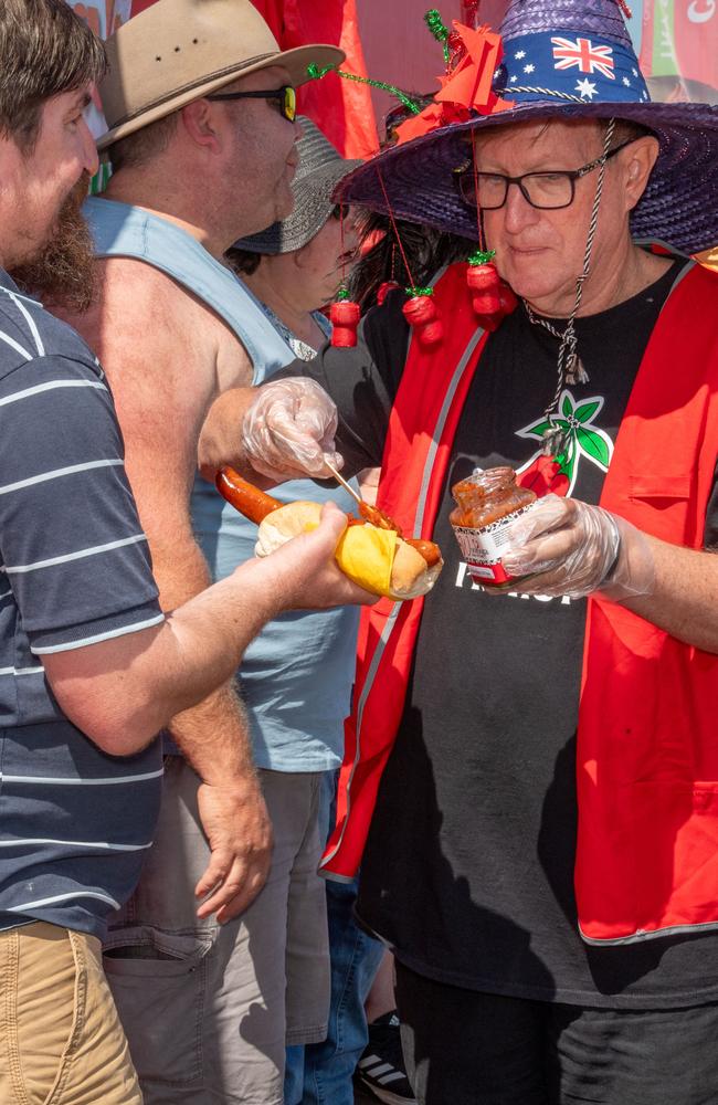 Wayne Marsh serves out the hot sauce at the Murphys Creek Chilli and Craft carnival. Sunday, September 22, 2024. Picture: Nev Madsen