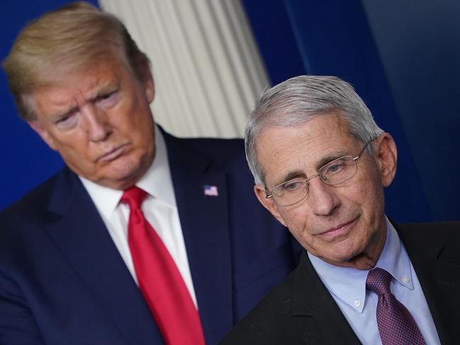 Dr Anthony Fauci, flanked by US President Donald Trump, says people should start wearing goggles and face shields if they can. Picture: AFP