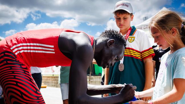 Australia's Gout Gout signs autographs.