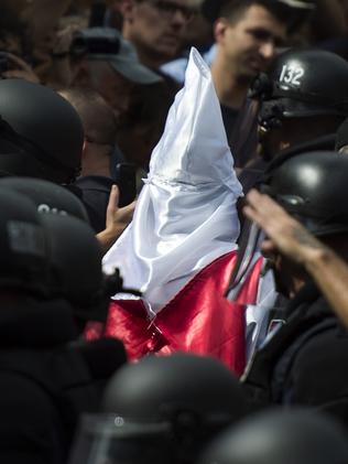 Police escort members of the Ku Klux Klan past protesters in Charlottesville, Virginia. Picture: AFP