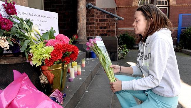 Kate MacNaughton lays flowers on the Brunswick Baptist Church's steps after the march.