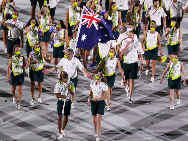 TOKYO, JAPAN - JULY 23: Flag bearers Cate Campbell and Patty Mills of Team Australia lead their team in during the Opening Ceremony of the Tokyo 2020 Olympic Games at Olympic Stadium on July 23, 2021 in Tokyo, Japan. (Photo by Clive Brunskill/Getty Images)