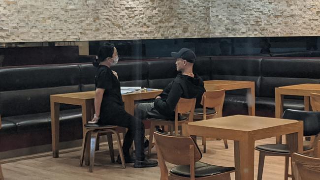 The owner of Madtongsan IV Korean restaurant at Sunnybank's Market Square (right) in conversation with an employee.