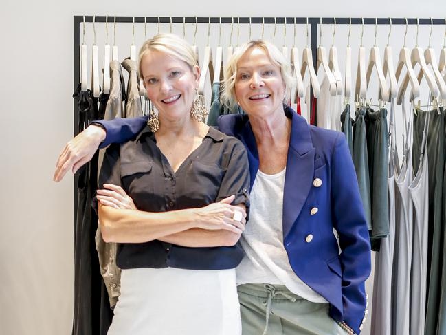 Stylist twins Sally Manhire (black top and Jane Corkill posing up in a clothes store as nominees for Women of the Year. Pic Tim Marsden