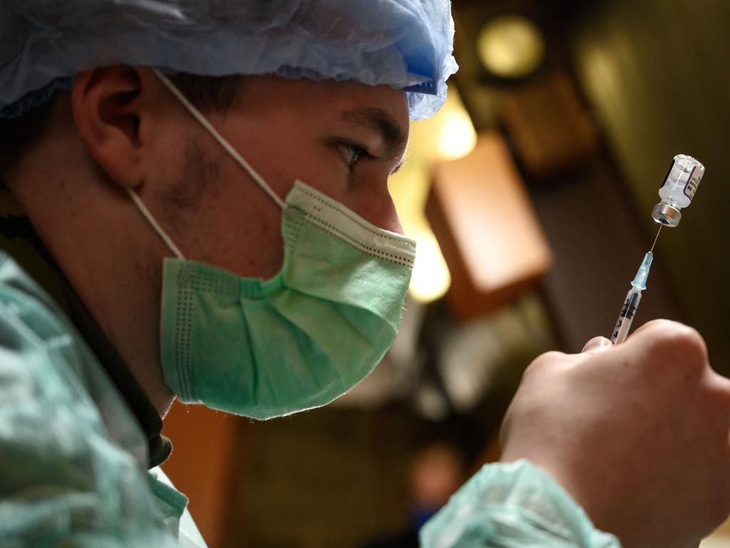 A Swiss soldier fills up a syringe with Pfizer. Picture: AFP