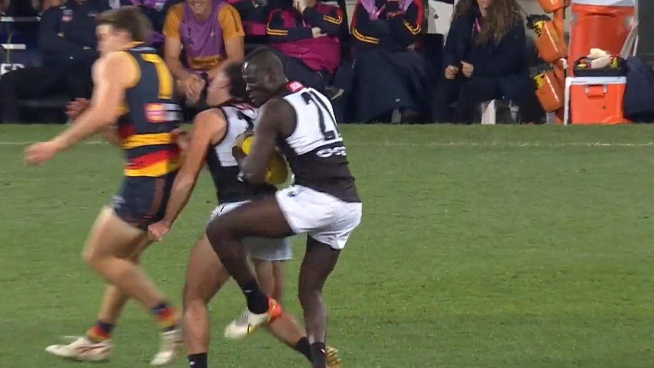 Aliir Aliir and Lachie Jones go for the ball in a contest with Adelaide forward Riley Thilthorpe. Picture: Fox Sports.