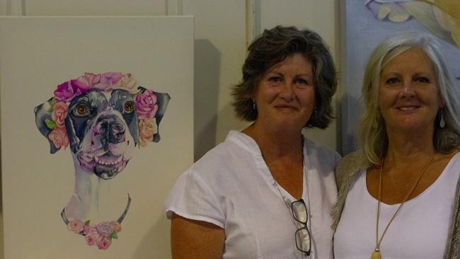 Alix O‘Neil and Judy Waters pose next to Alix's painting.