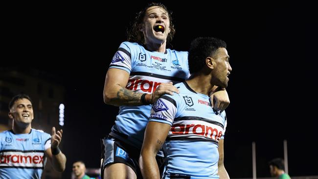 SYDNEY, AUSTRALIA - MARCH 31: Ronaldo Mulitalo of the Sharks celebrates scoring a try with Nicho Hynes of the Sharks during the round four NRL match between Cronulla Sharks and Canberra Raiders at PointsBet Stadium, on March 31, 2024, in Sydney, Australia. (Photo by Cameron Spencer/Getty Images)