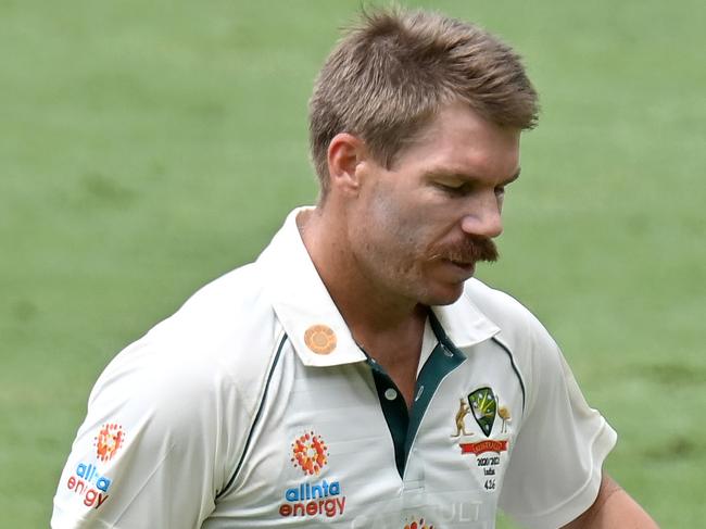 BRISBANE, AUSTRALIA - JANUARY 18: David Warner of Australia looks dejected after losing his wicket during day four of the 4th Test Match in the series between Australia and India at The Gabba on January 18, 2021 in Brisbane, Australia. (Photo by Bradley Kanaris/Getty Images)