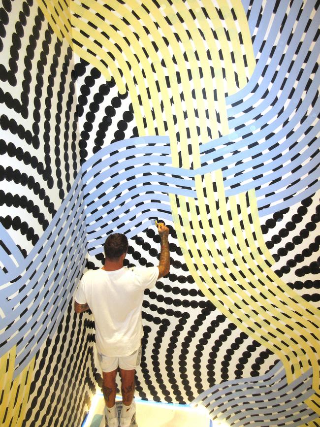 Artist Otis Hope Carey working on his mural in Louis Vuitton latest flagship store. Picture: Louis Vuitton/Supplied