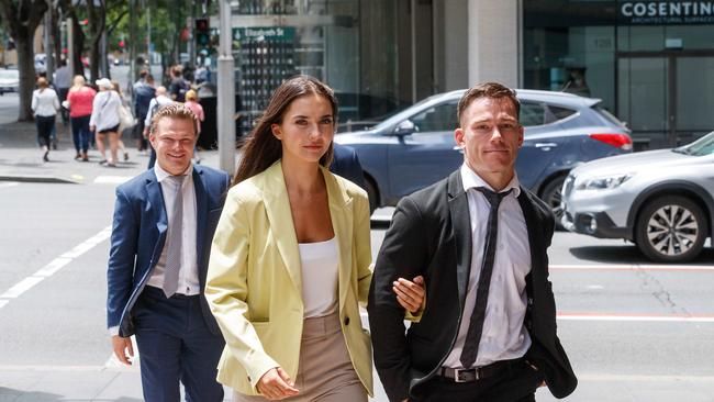 Tom Starling (right) arrives at Downing Centre Court earlier this month with his girlfriend and brother Josh (left). Picture: David Swift