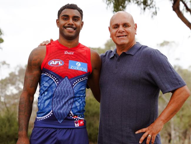Kysaiah Pickett and father Kevin Kropinyeri with Melbourne's 2025 Sir Doug Nicholls Round jumper. Picture: Melbourne FC