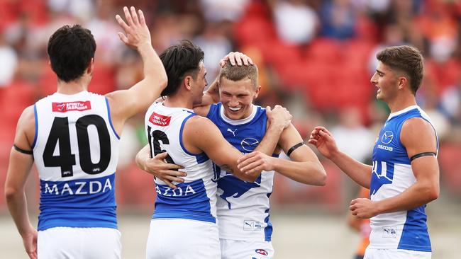 SYDNEY, AUSTRALIA - MARCH 16:  Zane Duursma of the Kangaroos celebrates with team mates after kicking a goal during the round one AFL match between Greater Western Sydney Giants and North Melbourne Kangaroos at ENGIE Stadium, on March 16, 2024, in Sydney, Australia. (Photo by Matt King/AFL Photos/via Getty Images )