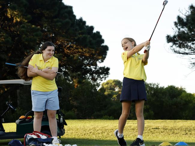 DAILY TELEGRAPH MARCH 19, 2024. Young golfers Elizabeth Savell, 14, (left) and Eliza Rolfe, 9, during a lesson at East Lakes Golf Club in Pagewood. Picture: Jonathan Ng