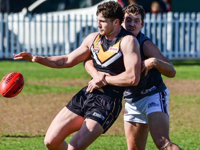 AUGUST 21, 2021: BrightonÃs Otis Carthy kicks under pressure during Adelaide Footy League division one match between Brighton Bombers and Port District at Brighton Oval. Picture: Brenton Edwards