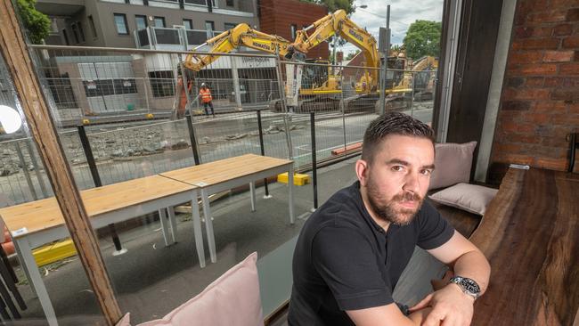 Paul Chatzis of Elephant Cafe in Flemington said business was only just recovering from lockdowns. Now the Mt Alexander Rd tram works are killing trade. Picture: Tony Gough