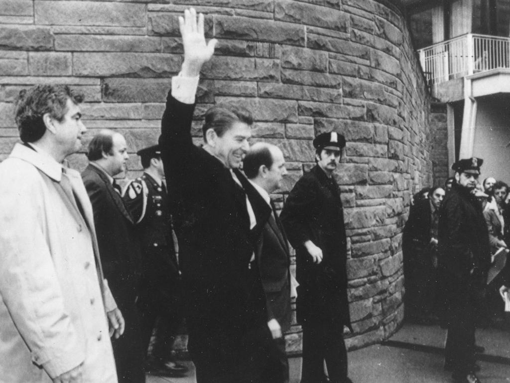 President Ronald Reagan waves just before being shot outside the Washington Hilton in Washington. From left are, Secret Service agent Jerry Parr, in raincoat, who pushed Reagan into the limousine; press secretary James Brady, who was seriously wounded; Washington policeman Thomas K. Delahanty, who was shot; and secret service agent Timothy J. McCarthy, who was shot in the stomach.