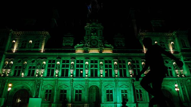 The City Hall of Paris was illuminated in green following Trump’s announcement. Picture: AFP