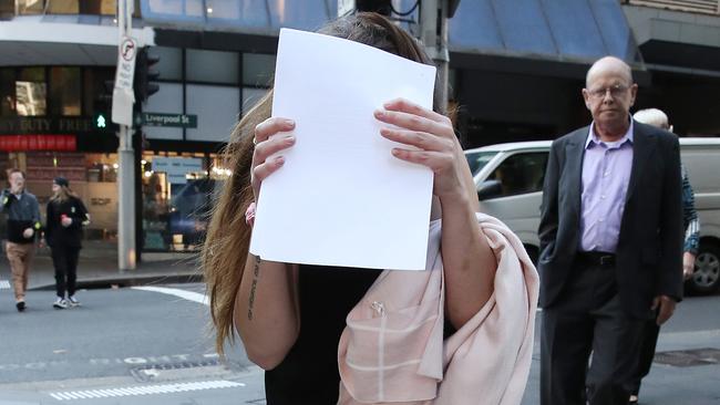 Cahill hid from media as she left court. Picture: NCA NewsWire / David Swift.