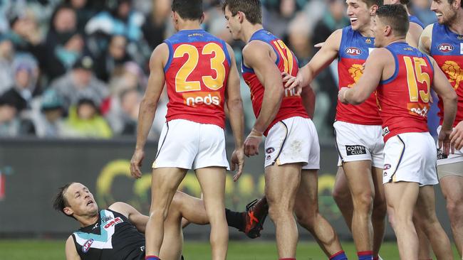 GET OUT OF OUR WAY: Brisbane players gang up on Port Adelaide’s Cam Sutcliffe after he tried to rough Lachie Neale up at Adelaide Oval last Sunday. Picture: SARAH REED.