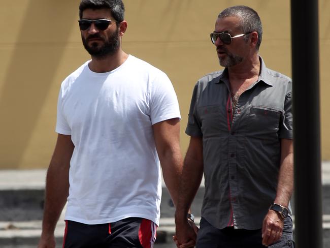 Musician George Michael walks hand in hand with Fadi Fawaz in Sydney back in 2012. Picture: Cameron Richardson
