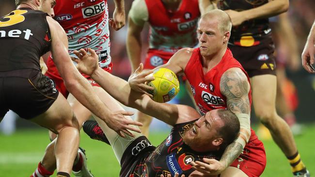 Sydney's Zak Jones and Hawthorn's Jarryd Roughead fight for the ball during the indigenous round AFL match Sydney Swans v Hawthorn at the SCG. Picture. Phil Hillyard