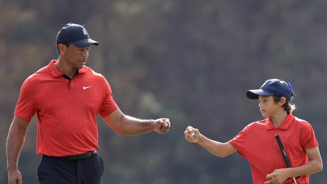 ORLANDO, FLORIDA - DECEMBER 19: Tiger Woods and Charlie Woods celebrate a birdie on the 13th hole during the final round of the PNC Championship at the Ritz Carlton Golf Club Grande Lakes on December 19, 2021 in Orlando, Florida. (Photo by Sam Greenwood/Getty Images)