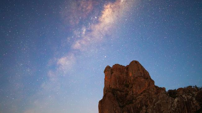 Stars lighting up the night sky over the Breadknife rock formation in Warrumbungle National Park. Picture: Daniel Tran