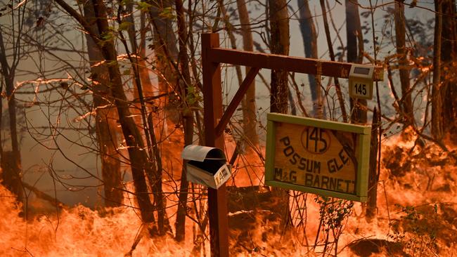 A bushfire burns outside a property near Taree, on the Mid North Coast of New South Wales. Picture: Peter Parks/AFP