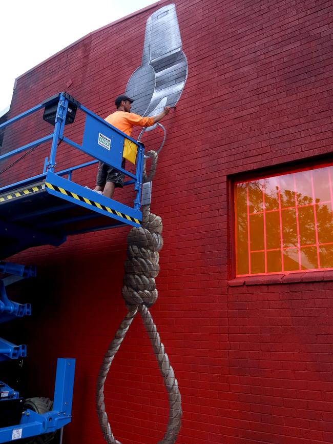 Artist Cam Scale working on "Don't Shoot the Messenger", in Proudfoots Lane at the M|Arts precinct in Murwillumbah.