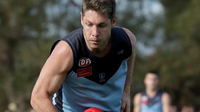 Luke Blackwell of Aberfeldie handballs as he is tackled during the EDFL Premier Division grand final between Aberfeldie and Keilor played at Windy Hill on Sunday 16th September, 2018.