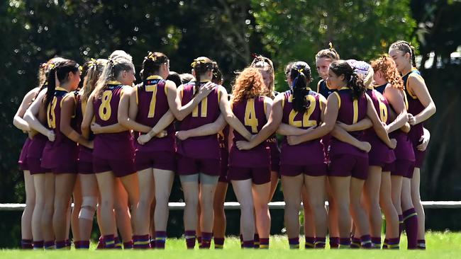 The Brisbane Lions Academy Girls huddle. (Photo by Albert Perez/AFL Photos via Getty Images)