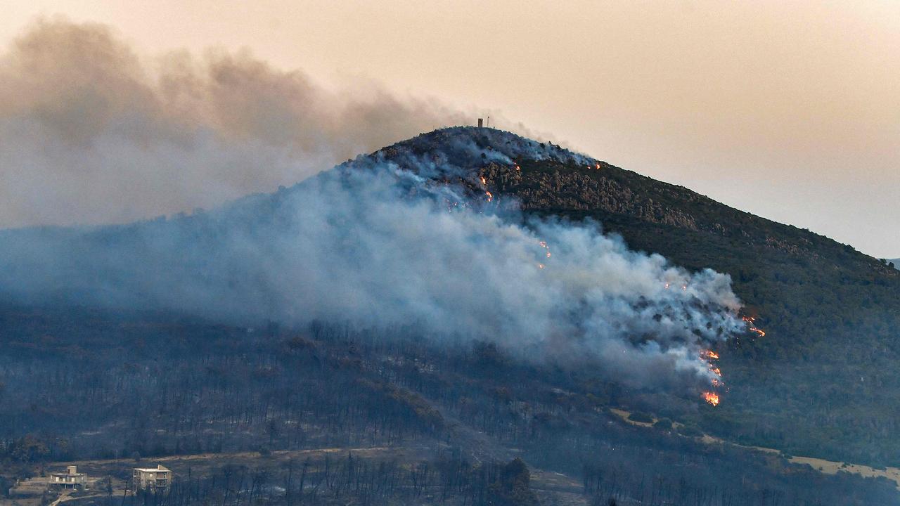 Fires raged again on July 24 in a Tunisian pine forest near the border with Algeria, after another blaze in the area the prior week. (Photo by Fethi Belaid