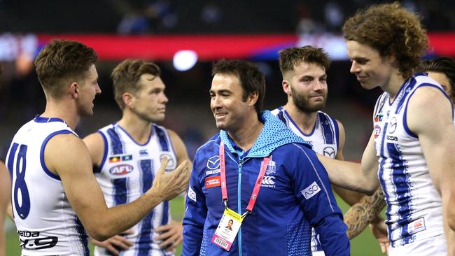 North Melbourne coach Brad Scott celebrates with his players post-match. Picture: AAP Image/Hamish Blair.