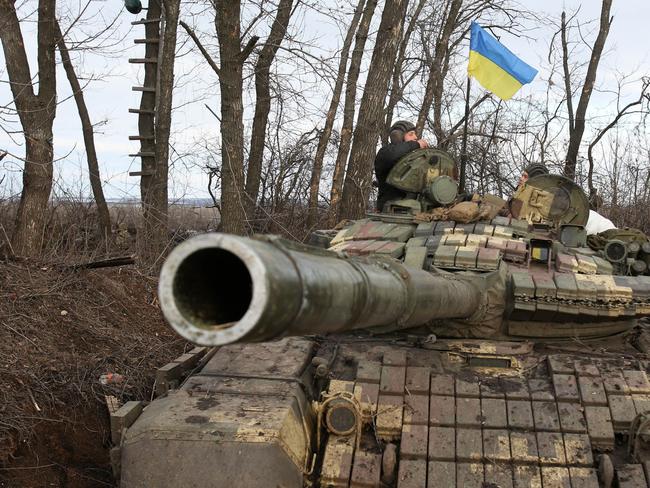 Servicemen of the Ukrainian Military Forces speak after following their battle against Russian troops and Russia-backed separatists near Zolote village. Picture: AFP