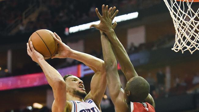 Philadelphia 76ers guard Ben Simmons, left, shoots as Houston Rockets forward Luc Mbah a Moute defends during the second half of their NBA game today. Photo: AP