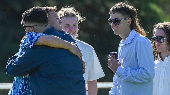 The brother of Antonio Loiacono, Jack (in blue patterned shirt) hugs friends at the wake. Picture: NCA NewsWire / Naomi Jellicoe