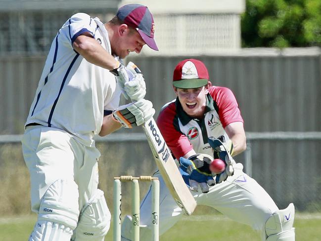 Tooradin keeper Tom Hussey and Pakenham batsman Russ Lehman. Picture: Valeriu Campan