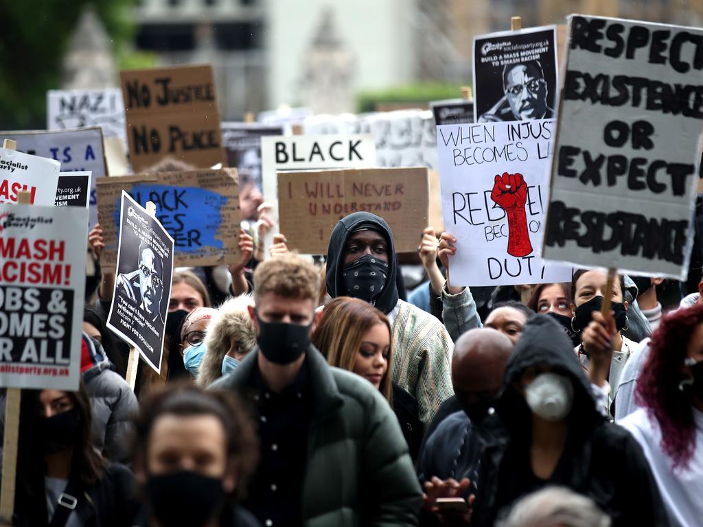 Protesters hold their signs during the demonstration. Picture: Alex Pantling/Getty Images